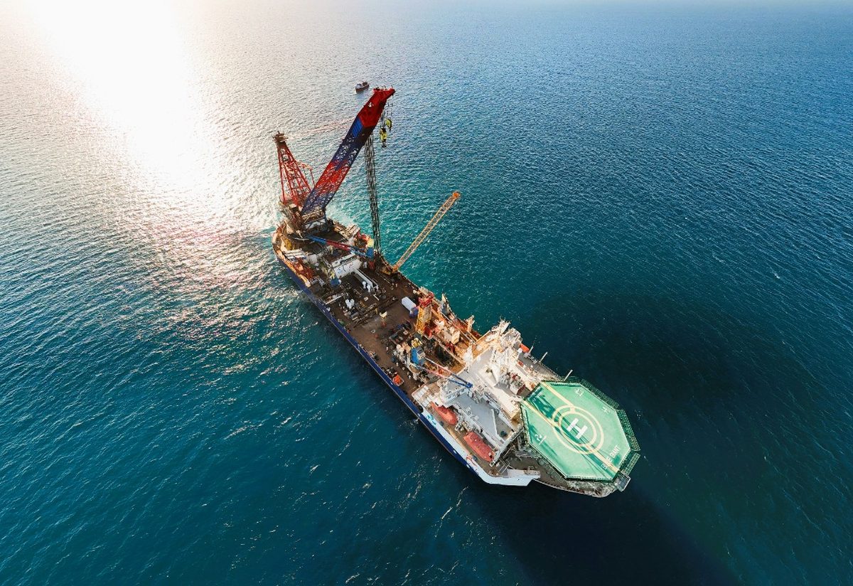Aerial view of a heavy-lift offshore construction vessel with helideck